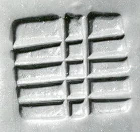 Loop-handled rectangular stamping device by Unknown Artist