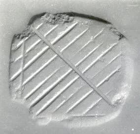 Loop-handled rectangular stamping device by Unknown Artist