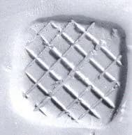 Loop (?) handled rectangular stamping device by Unknown Artist