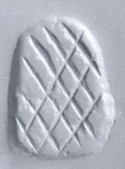 Loop-handled wedge-shaped stamping device by Unknown Artist