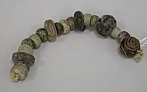 String of flattened beads by Unknown Artist