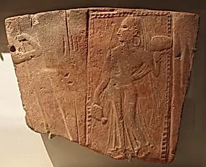Tile showing a woman carrying a pot by Unknown Artist