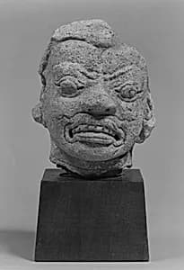 Head of a Grimacing Male Deity by Unknown Artist