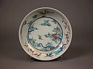 Shallow Bowl with Design of Dragon amid Waves, Phoenix, and Flowers by Unknown Artist