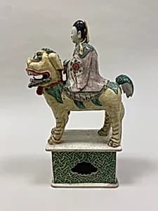 Figure of Bodhisattva Guanyin riding a lion by Unknown Artist
