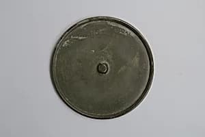 Mirror with Incised Design of Buddha Triad by Unknown Artist