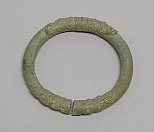 One from a Pair of Solid Anklets with Spiral Decoration by Unknown Artist