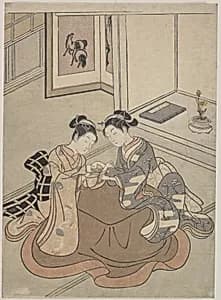 Two Young Women Seated by a Kotatsu Playing Cat's Cradle by Suzuki Harunobu