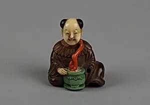 Netsuke of Seated Man with a Flower Pot by Unknown Artist