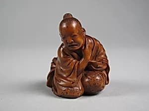 Netsuke of Man Applying Salve by Unknown Artist