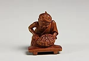 Netsuke of Man Cutting Pumpkin by Unknown Artist