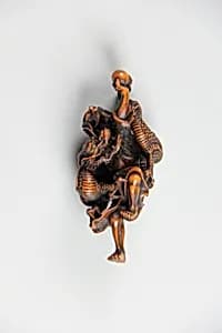 Netsuke of Dragon Coiled around the Body of a Man by Unknown Artist