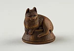 Netsuke of Cat Lying on a Bowl, underneath which is a Fish by Unknown Artist