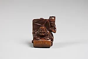 Netsuke of Demon and an Old Man with a Scroll by Unknown Artist