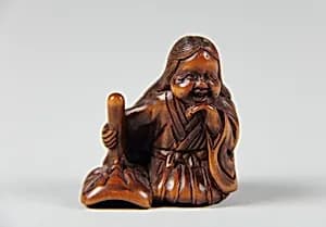 Netsuke of Girl with a Mask by Unknown Artist