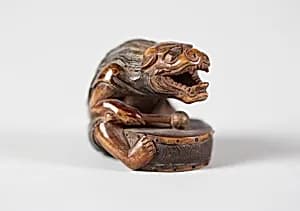 Netsuke of Masked Figure with a Drum by Unknown Artist