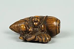 Netsuke of Old Man Carrying a Very Large Acorn by Unknown Artist