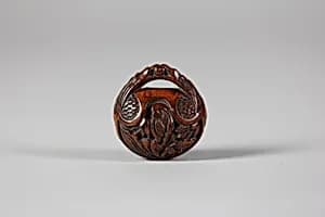 Netsuke in the form of a Nut Containing a Carved Landscape by Unknown Artist