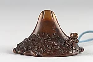 Netsuke in shape of Mount Fuji with Traveling Monk and Pine by Unknown Artist