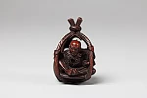 Netsuke of Old Man in a Basket by Unknown Artist