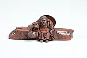 Netsuke of Woman Sitting on a Log by Unknown Artist