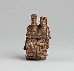Netsuke of Man and Woman Sitting on a Box by Unknown Artist