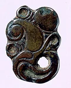 Garment Plaque in the Shape of a Raptor's Head by Unknown Artist