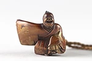 Netsuke of Sambaso Dancer with Bells and Fan by Unknown Artist