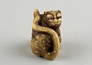 Netsuke of Seated Tiger with a Curled-up Tail Across its Back by Unknown Artist