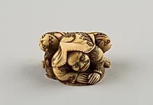 Netsuke of a Hunter Trying to Catch a Fox Beneath a Straw Hat by Shūōsai