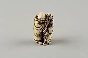 Netsuke of Man and Two Children with a Sambaso Dancer Puppet by Masahide