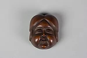 Netsuke of Noh mask; Face of Usume by Unknown Artist