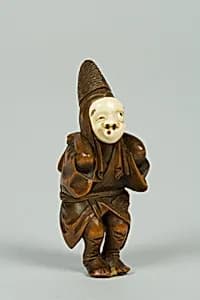 Netsuke of Boy Wearing an Ivory Mask by Unknown Artist