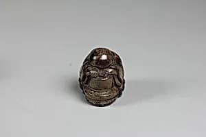 Netsuke of of a Priestling Asleep over a Stonemill by Unknown Artist