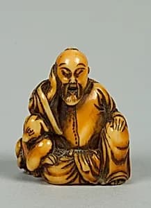 Netsuke of Seated Figure of Old Man with a Dog by Unknown Artist