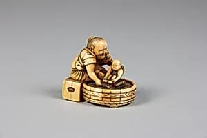 Netsuke of Old Woman Bathing Child in a Tub by Unknown Artist
