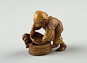 Netsuke of Man Forcing Monkey into a Basket by Unknown Artist