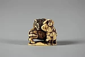 Netsuke of Man Leading an Ox with Bundles of Wood on its Back by Unknown Artist