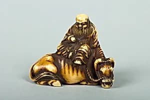 Netsuke of Man Sitting on a Recumbent Ox by Unknown Artist