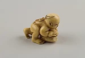Netsuke of Child with a Shell by Unknown Artist