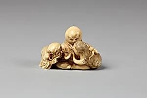 Netsuke of Daruma Admonishing a Mermaid Serving Sake to an Octopus by Unknown Artist