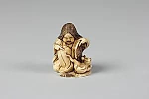 Netsuke of Girl Playing with a Cat by Unknown Artist