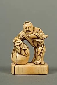Netsuke of Man with a Bag, Standing on a Block by Unknown Artist