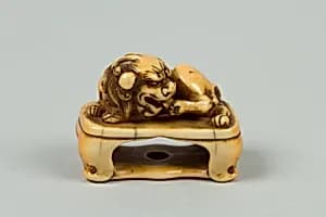 Netsuke of Lion on a Stand by Unknown Artist