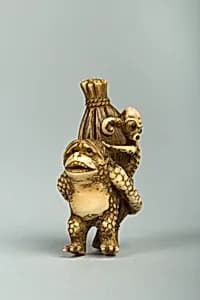 Netsuke of Monkey Carrying an Octopus Bound in Bamboo on His Back by Unknown Artist