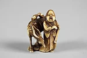 Netsuke of Female Figure (Okame) with a Deer by Unknown Artist