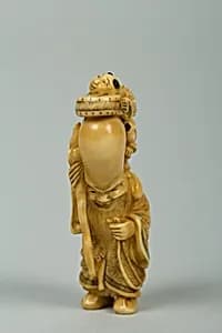 Netsuke of Fukurokujin with Tall Head and Two Children Climbing on It by Unknown Artist