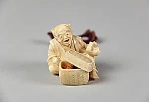 Netsuke of Old Man with a Basket Containing Four Miniature Ivory Masks by Unknown Artist