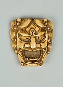 Netsuke of Mask of a Man with Open Mouth and Curly Hair by Unknown Artist