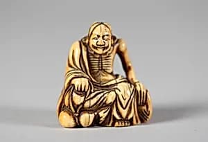 Netsuke of Old Man Seated on a Rock by Unknown Artist